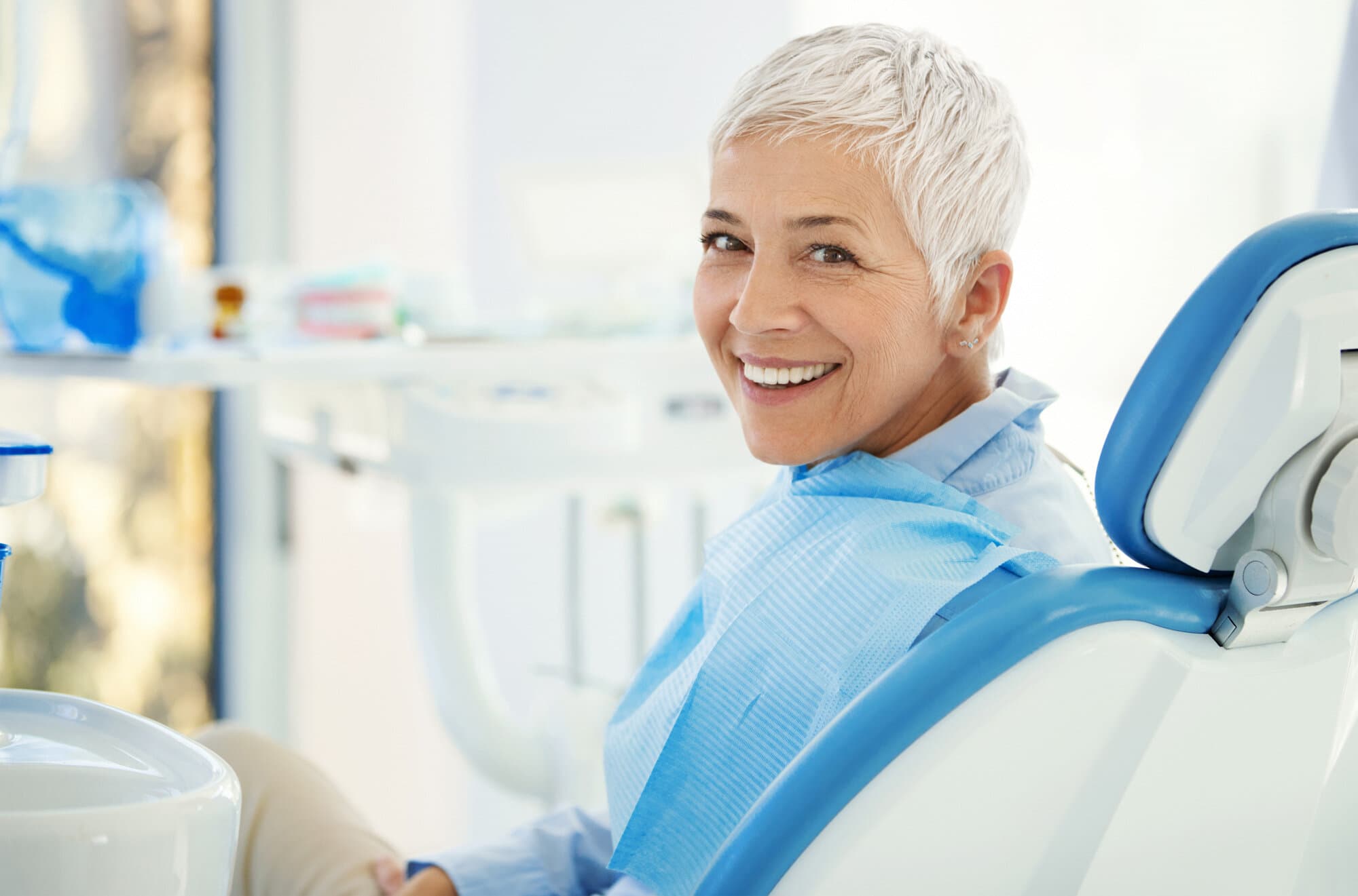 A smiling senior patient relaxed in the dental chair