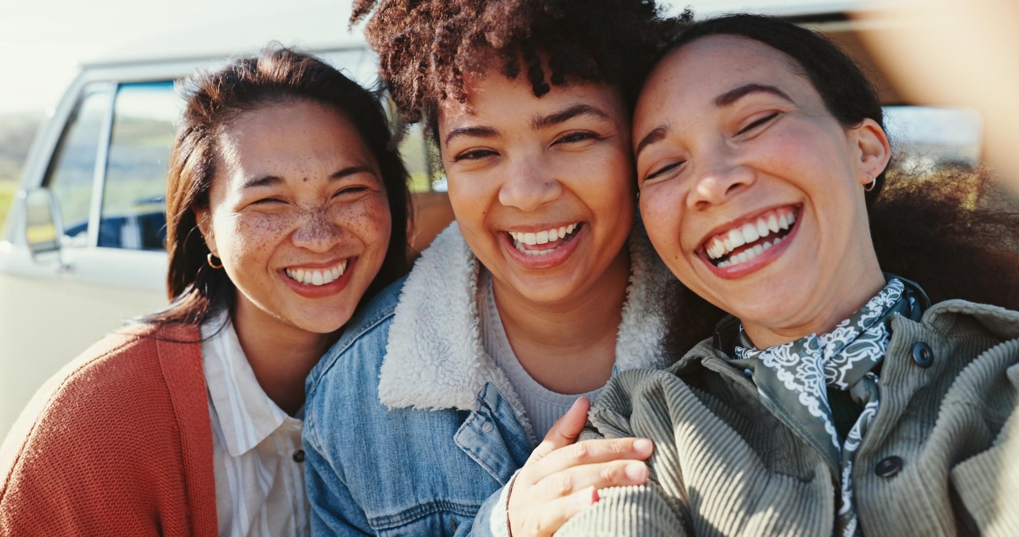 Three friends laughing together