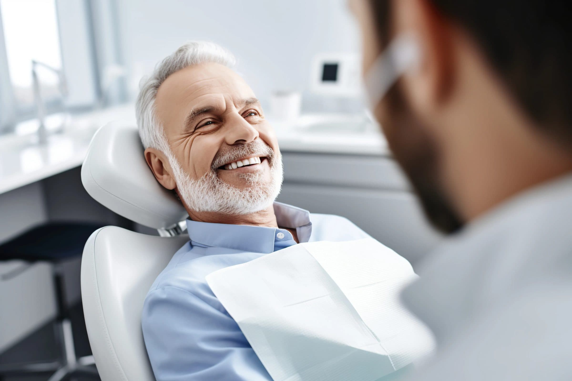 A patient smiling with their dentist during a treatment consultation